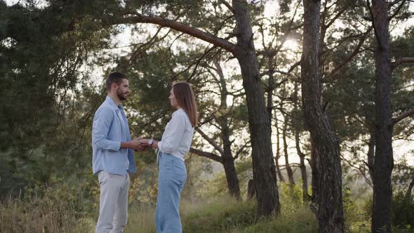 Closeup of Man and a Wooman That Joining Hands Together on Nature Background