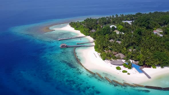 Aerial drone seascape of tropical seashore beach voyage by blue water with sand background