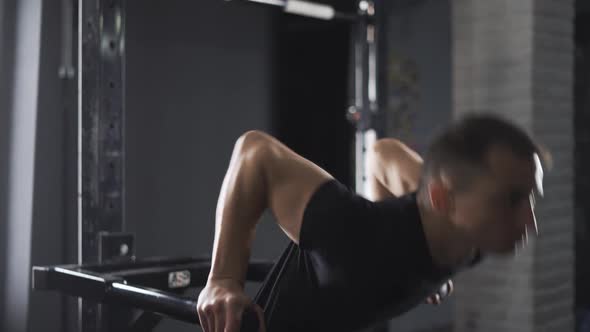 Workout Young Disabled Athlete in Wheelchair Performs Pushups on Bars Gym Training and Physical