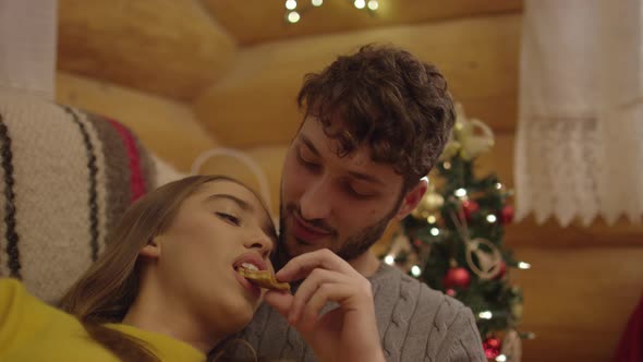 Man feeding a woman cookie