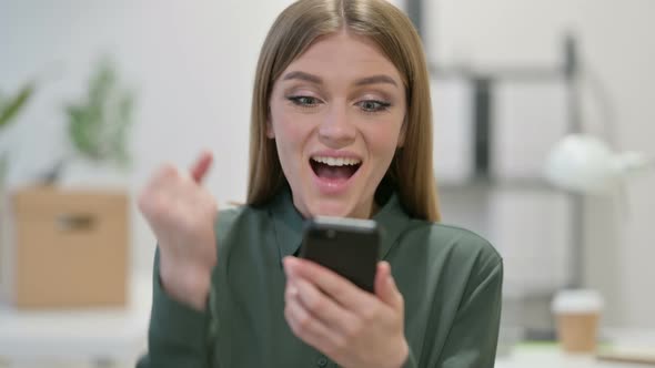 Portrait of Young Woman Celebrating on Smartphone