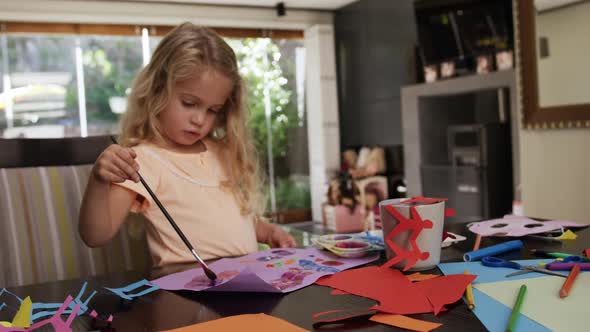 Mother and daughters painting together