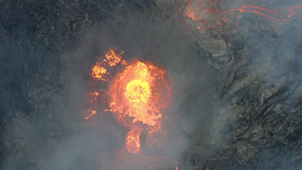 Smoke moving over a active Volcanic crater - Aerial static, overhead drone view