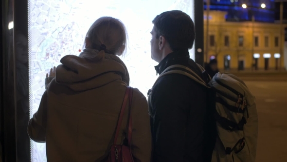 Tourists Checking The Pad Route With Street Map