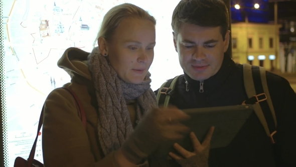 Tourists Walking In Tallinn With Tablet