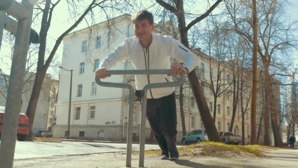 Man Doing Sports Using Bike Parking Rack