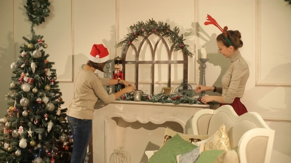 Two Girls Decorate a Room For Christmas