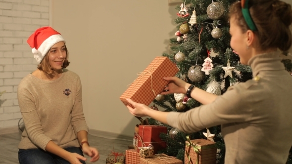 Happy Girls Give Christmas Gifts 