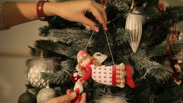Girl Hangs On a Beautiful Christmas Tree Toy
