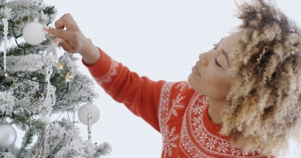 Attractive African Woman Decorating An Xmas Tree