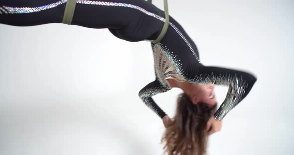 Woman is Hanging on Strings Beautiful Aerial Silks Performance Studio