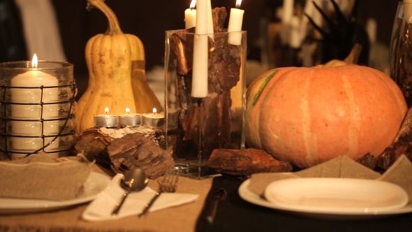 Candle And Pumpkins On a Table