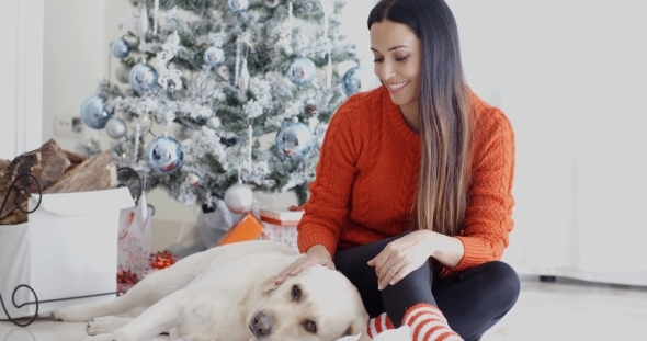 Laughing Young Woman With Her Dog At Christmas