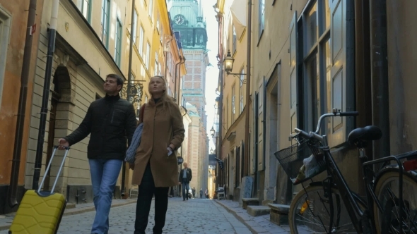 Man And Woman With Travel Bag Wandering In Old