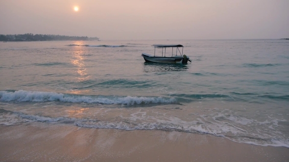 Calm Sea With a Alone Sway Boat At Sunrise