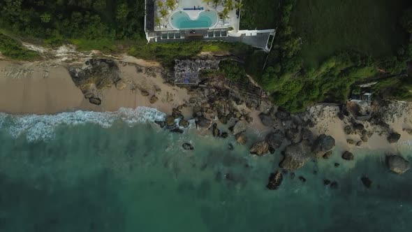 Beautiful Bingin beach with exotic cliffs houses and hotel located in Bali, Indonesia. This drone fo