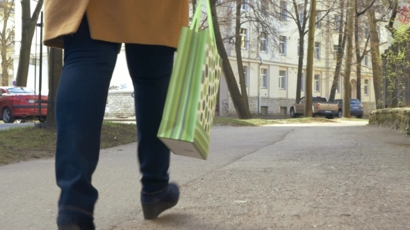 Woman Walking With Green Shopping Bag