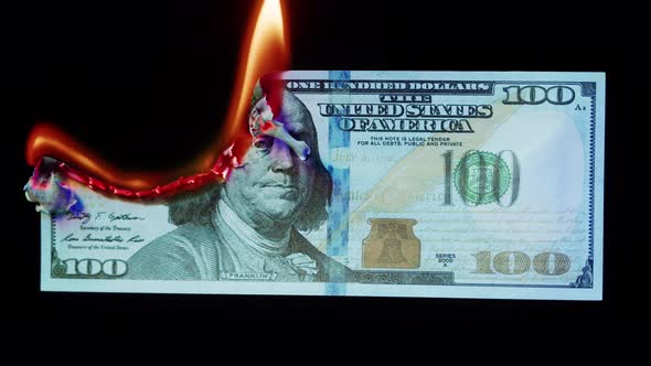 Burning American Hundred Dollar Banknote on Black Background