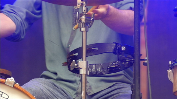 A Man in Jeans Practicing his Drums