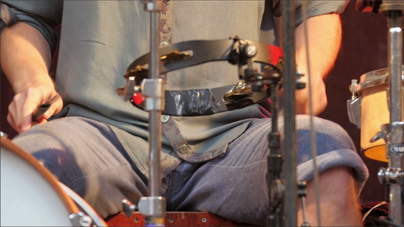 The Drummer Playing the Sticks on his Lap alt