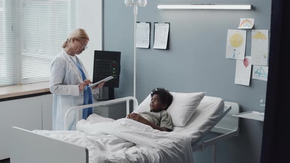 Doctor Talking to Boy in Hospital Room