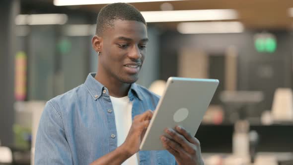 Attractive Young African American Man Using Tablet