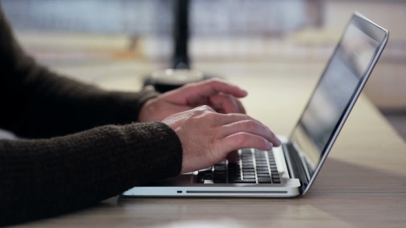Man Hands Working On Laptop In The Workplace