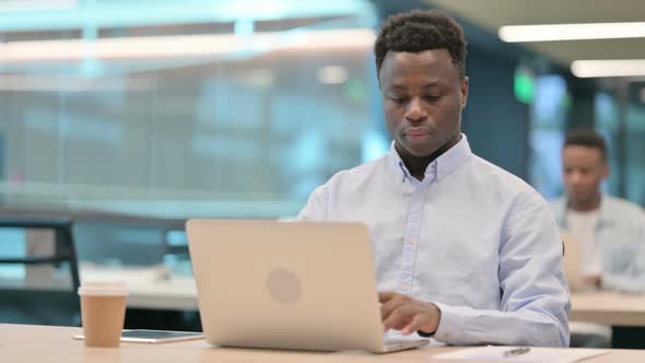 African Businessman Working on Laptop in Office