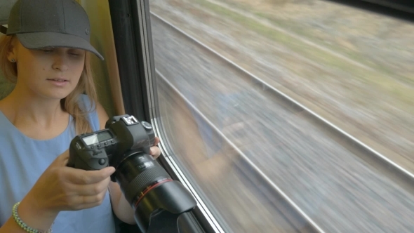 Young Girl Going By Train And Taking Pictures.