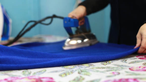 Woman Irons Clothes