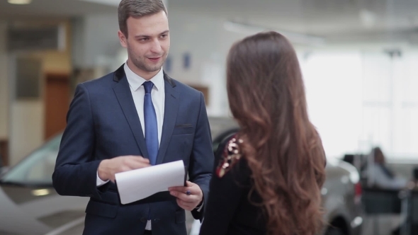 Salesman Explaining Contract Conditions To Woman alt