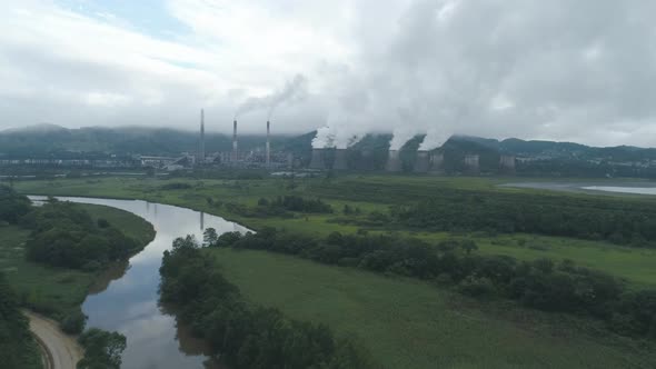 Aerial Drone View of Smoking Pipes and Cooling Towers of Coal Thermal Power Plant