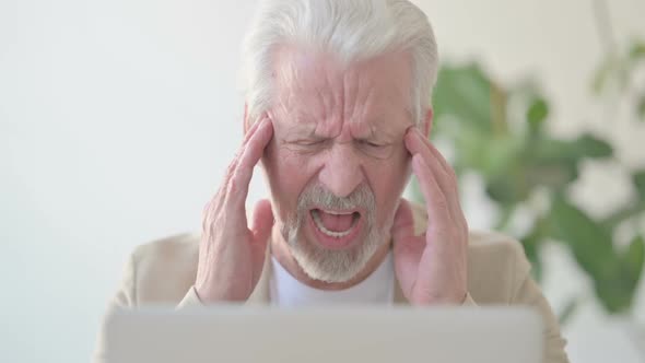Close Up of Old Man Having Headache While Working on Laptop