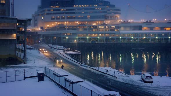 City Harborside Scene With Snow Falling In The Evening