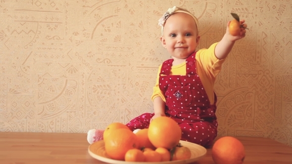 Child With Oranges And Tangerines
