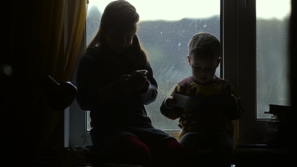 Children Sitting On The Windowsill