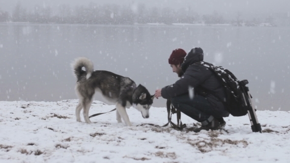Man Playing With a Dog In Winter