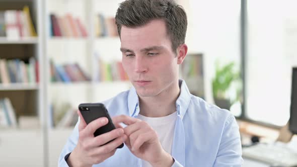 Cheerful Young Student Using Smartphone