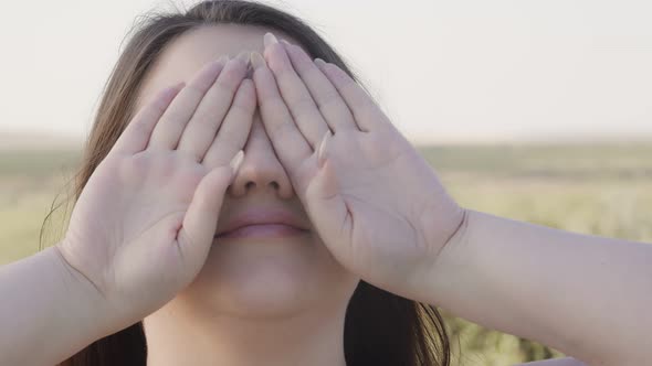 Body Positive Young Woman Covered Her Face with Her Hands Palms Forward