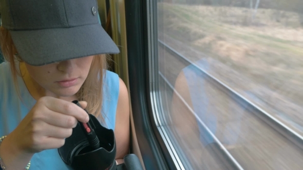 Young Woman Taking A Photo On Train