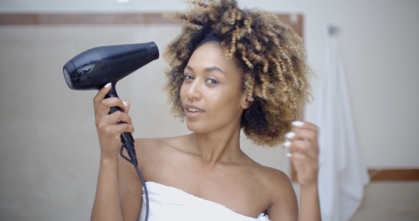 Woman Drying Her Hair With Hairdryer
