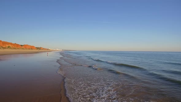 Aerial Flight Over a Beautiful Evening Beach at Low Tide and a Mirrored Surface That Reflects the