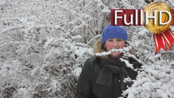 Woman Looking Out from Snowy Bushes