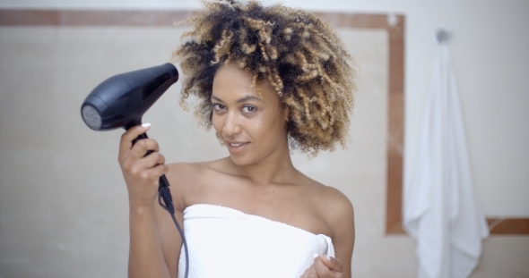 Woman Drying Her Hair With Hairdryer