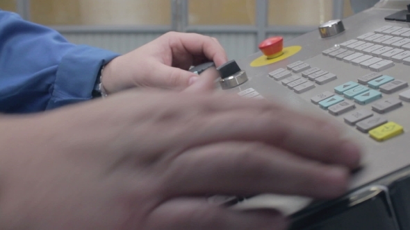 Man Sets Up An Industrial Machine Control Panel