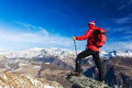 Hiker takes a rest admiring the mountain landscape. - PhotoDune Item for Sale