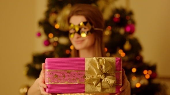 Smiling Woman Giving a Present