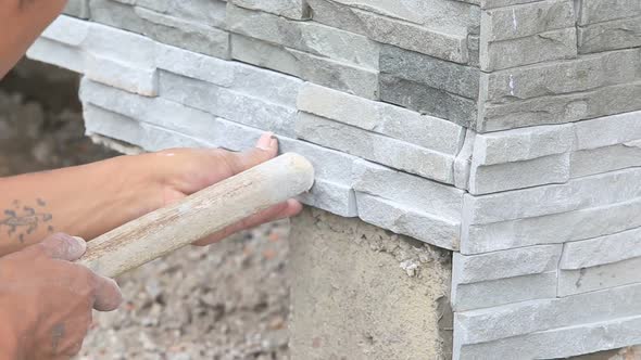 Worker Install Stone Wall Surface With Cement For House 11