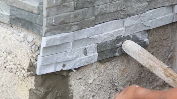 Worker Install Stone Wall Surface With Cement For House 2