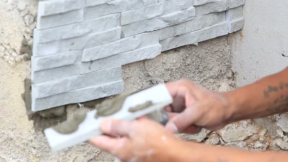 Worker Install Stone Wall Surface With Cement For House 8